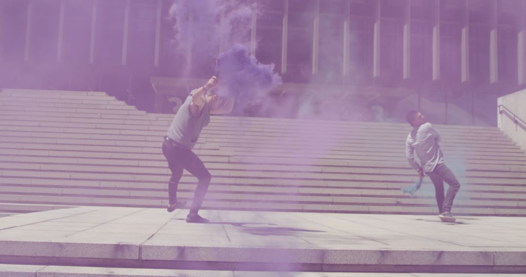 Two Men Celebrating With Purple Smoke Bombs on City Steps - Free Images, Stock Photos and Pictures on Pikwizard.com