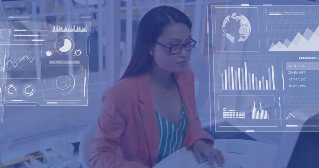 Asian Businesswoman Analyzing Financial Data on Computer in Office