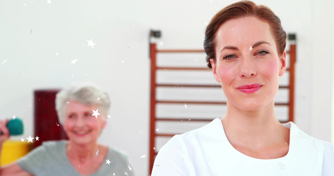 Smiling physiotherapist standing with senior patient lifting dumbbell during rehab session