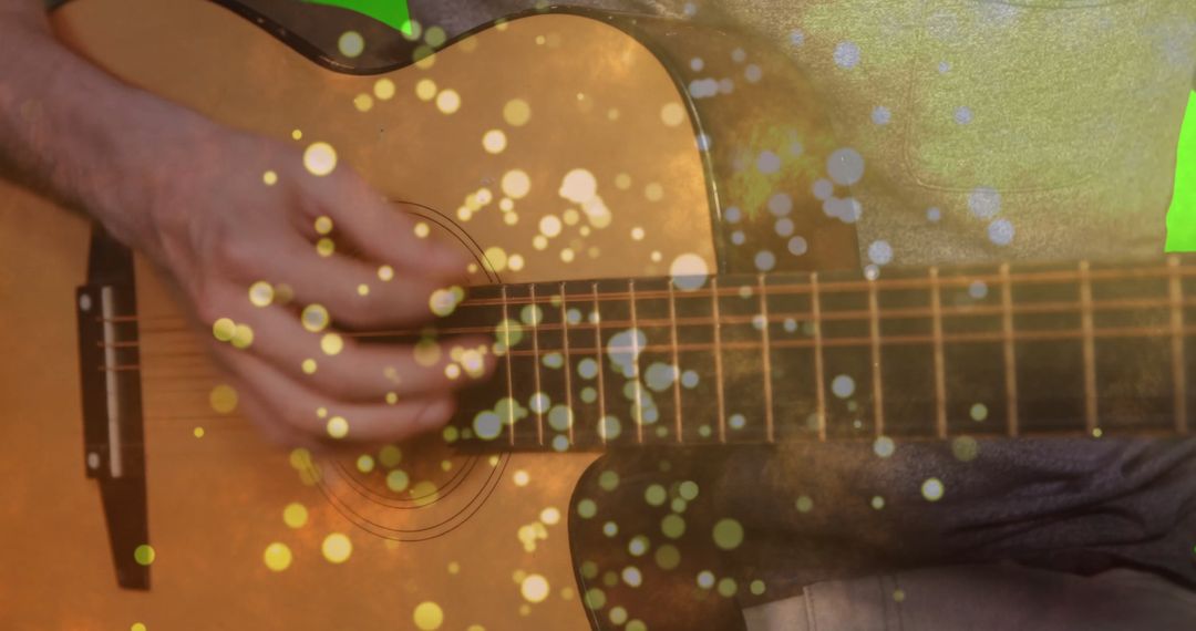 Person Playing Acoustic Guitar with Bokeh Effect