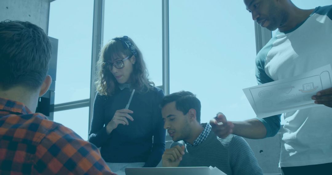 Collaborative Team Reviewing Designs in Modern Office Setting