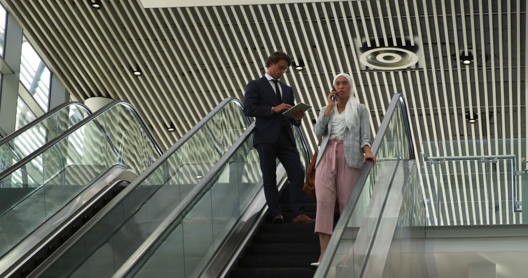 Young Professionals on Escalator in Modern Office Building - Free Images, Stock Photos and Pictures on Pikwizard.com