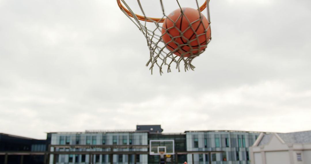 Basketball Scoring Shot Through Hoop Outdoors - Free Images, Stock Photos and Pictures on Pikwizard.com