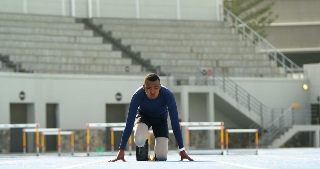 Paralympic Athlete on Starting Blocks at Empty Stadium for Track Race - Free Images, Stock Photos and Pictures on Pikwizard.com