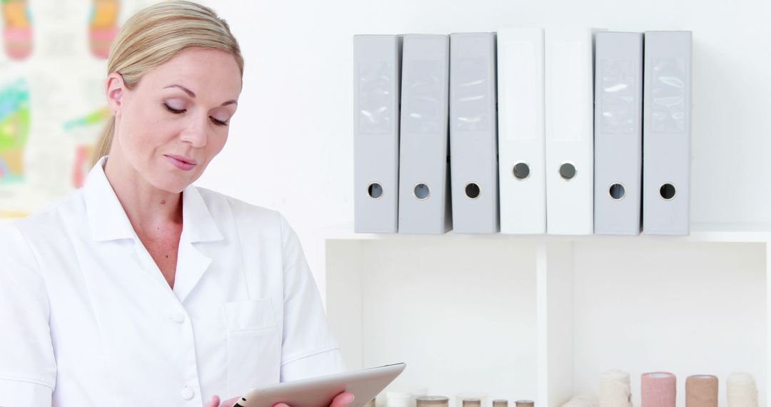 Professional Female Doctor Working on Tablet in Medical Office - Free Images, Stock Photos and Pictures on Pikwizard.com