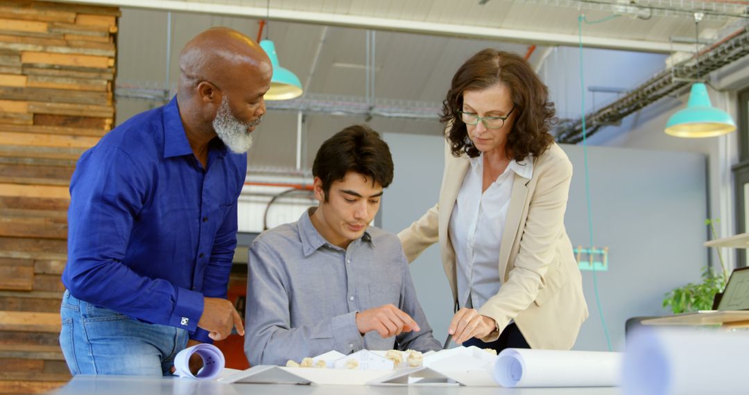 Diverse Team Collaborating on Project in Modern Office Workspace
