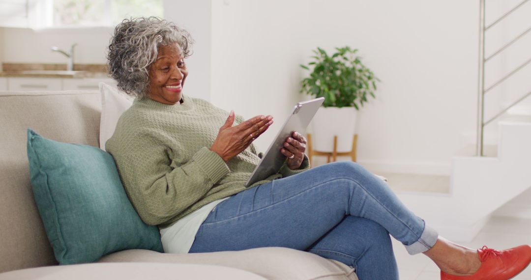 Senior Woman Using Digital Tablet Relaxing at Home - Free Images, Stock Photos and Pictures on Pikwizard.com