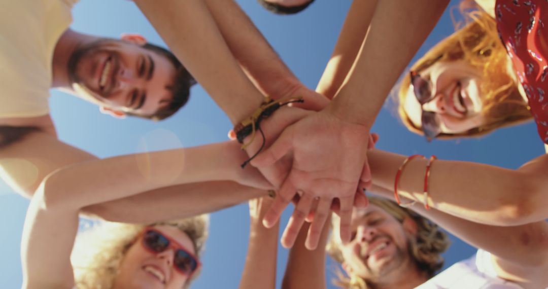 Low Angle View of Multiracial Friends Stacking Hands in Unity - Free Images, Stock Photos and Pictures on Pikwizard.com