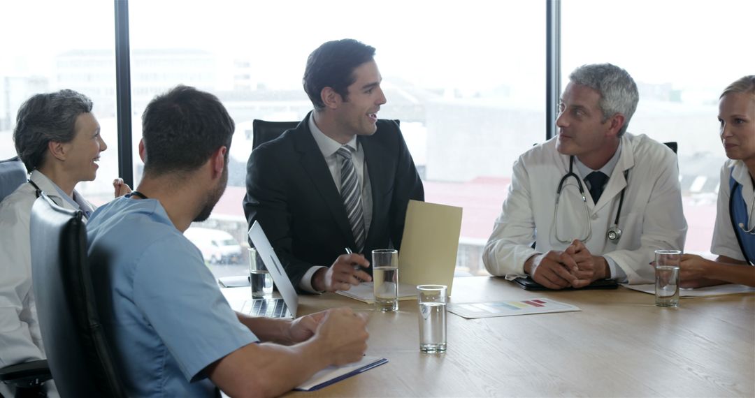 Medical Professionals Discussing Healthcare Strategy in Modern Office - Free Images, Stock Photos and Pictures on Pikwizard.com