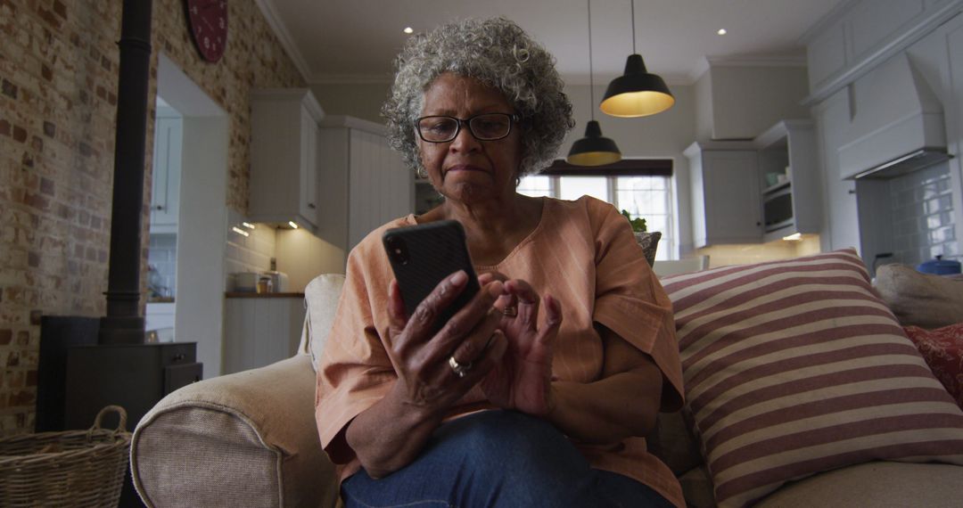 Elderly black woman enjoys coffee and smartphone during home quarantine. - Free Images, Stock Photos and Pictures on Pikwizard.com