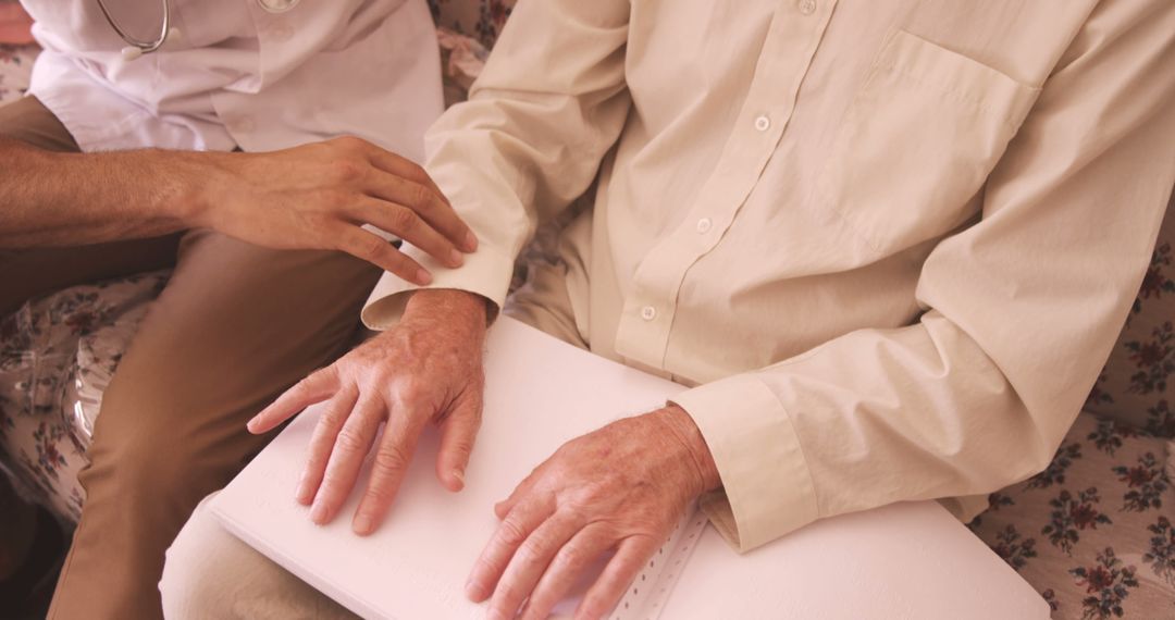 Visually Impaired Senior Reading Braille with Assistance - Free Images, Stock Photos and Pictures on Pikwizard.com