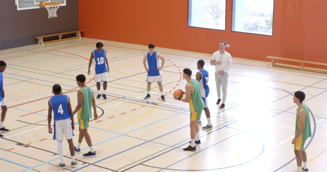 Team Practicing Basketball on Indoor Court