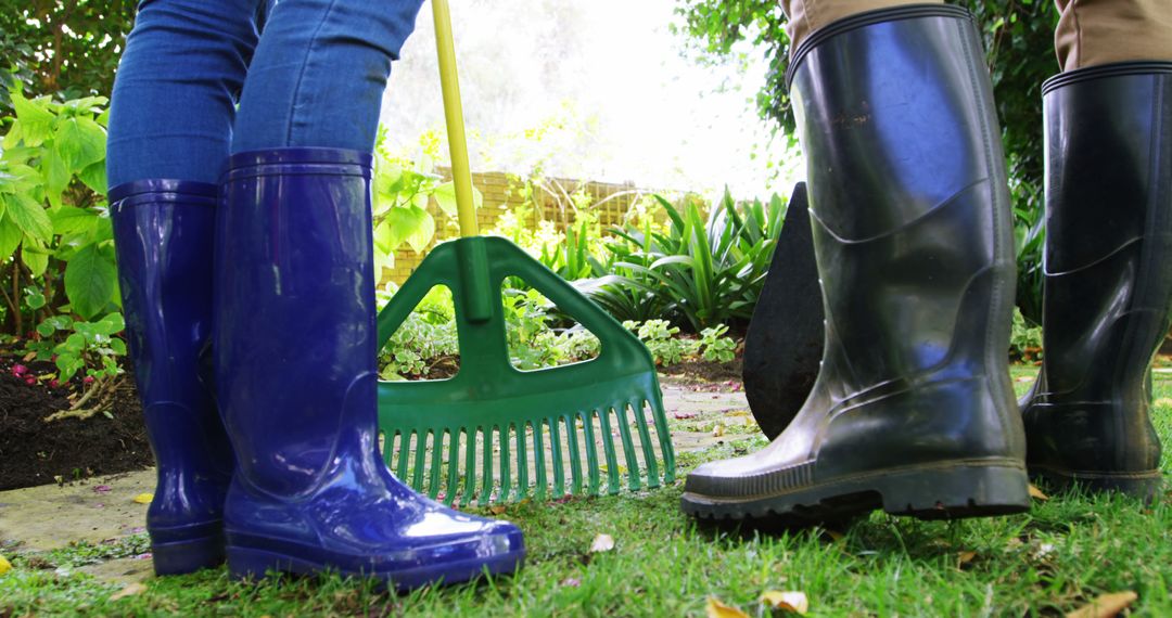 Gardeners Wearing Rubber Boots Cleaning Backyard Garden - Free Images, Stock Photos and Pictures on Pikwizard.com