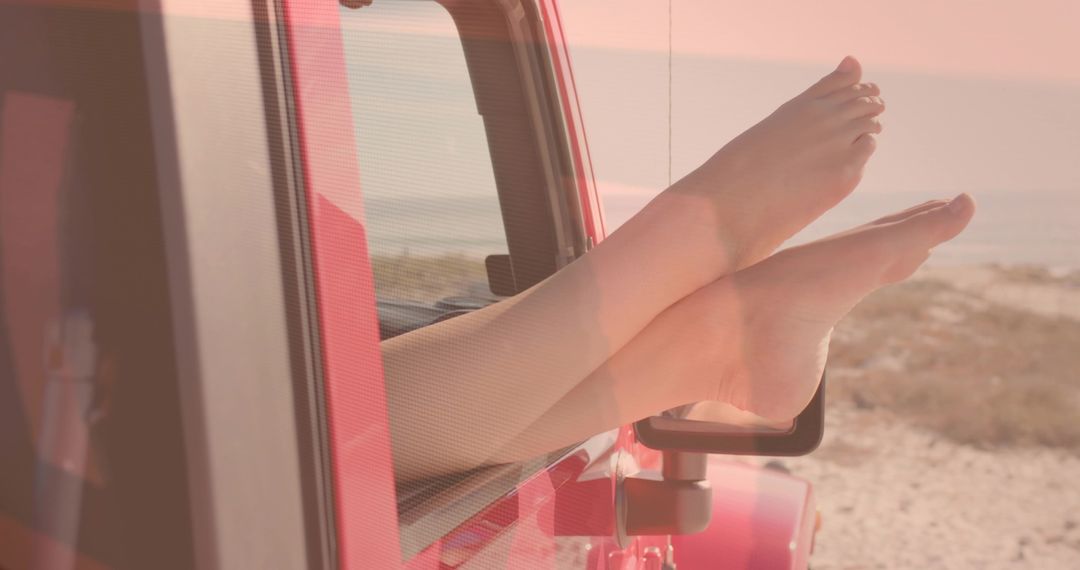 Relaxing Bare Feet Protruding from Red SUV on Beachfront