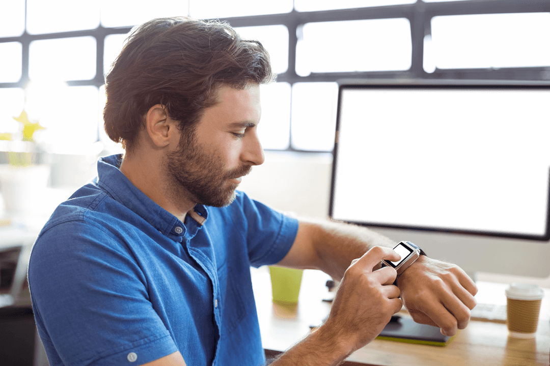Businessman Adjusting Smartwatch in Modern Office with Transparent Screen