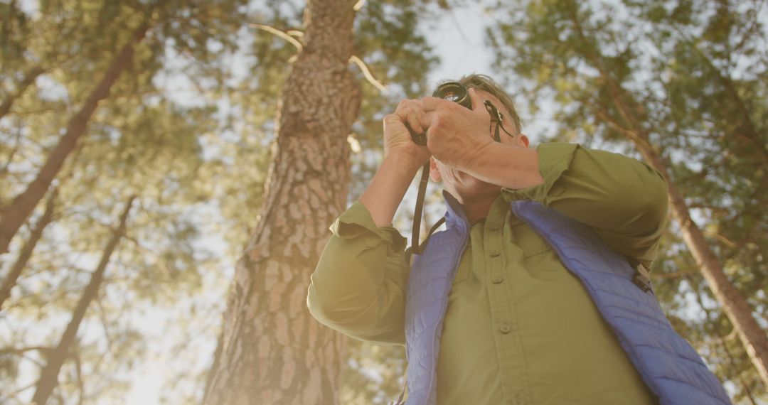 Mature Man Photographing Nature in Forest - Free Images, Stock Photos and Pictures on Pikwizard.com