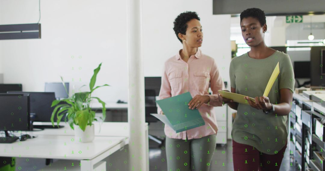 Professional Colleagues Discussing Work in Open-Plan Office
