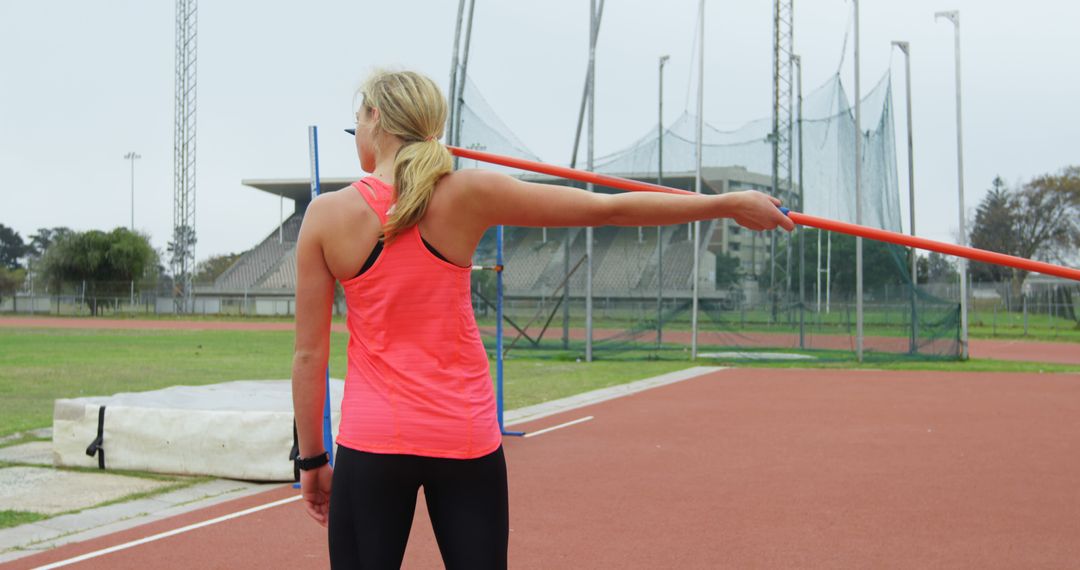 Female Athlete Practicing Javelin Throw on Track and Field - Free Images, Stock Photos and Pictures on Pikwizard.com