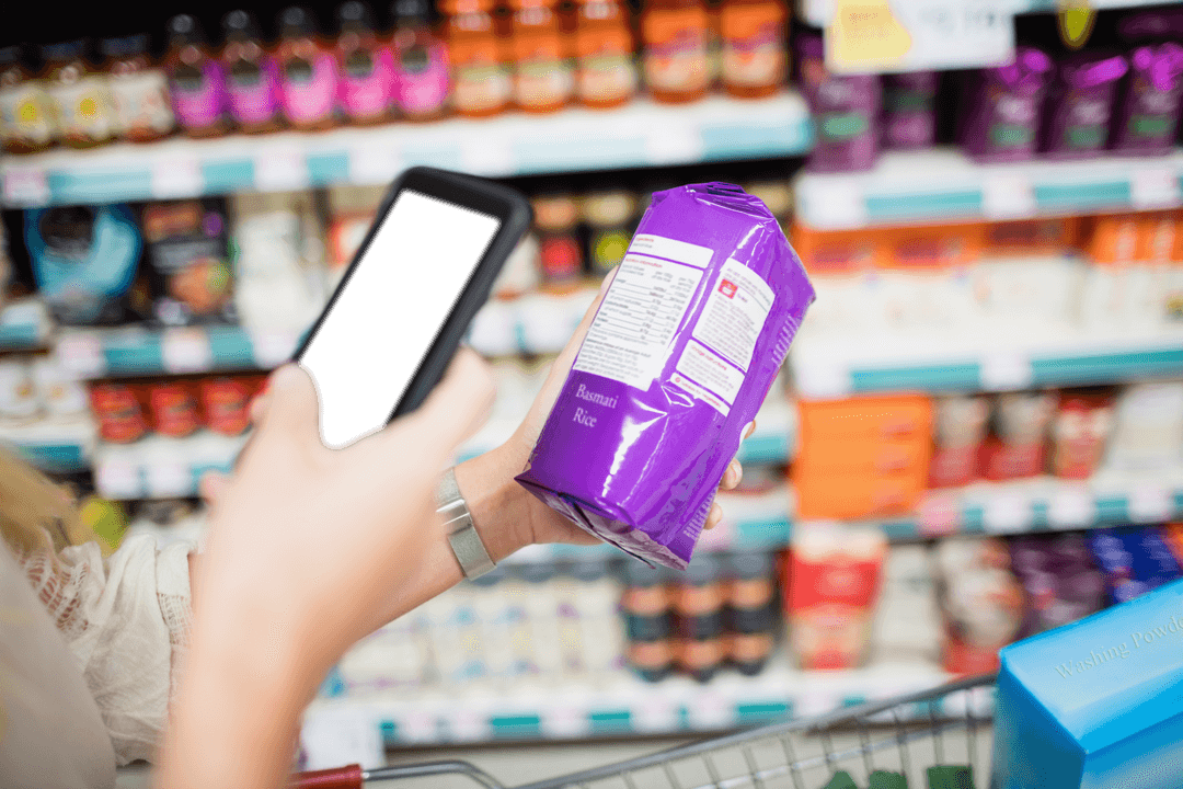 Woman Capturing Product Details on Smartphone in Grocery Aisle