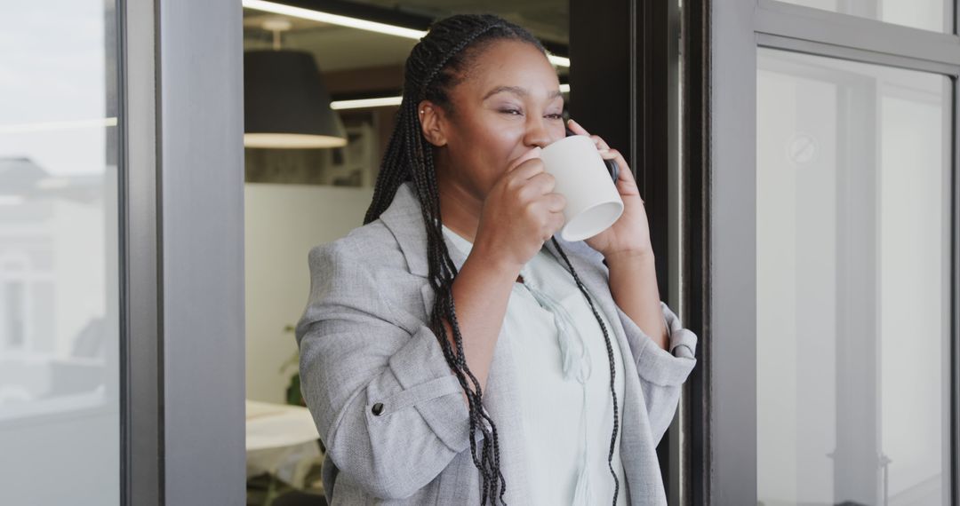 Businesswoman Enjoying Coffee Break in Modern Office - Free Images, Stock Photos and Pictures on Pikwizard.com