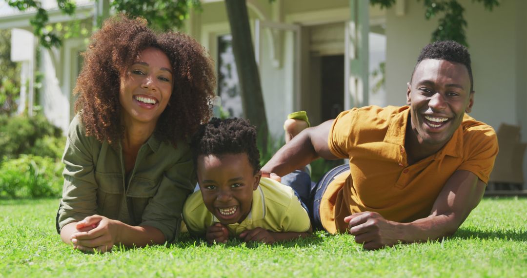 Happy African American Family Relaxing on Green Grass at Home - Free Images, Stock Photos and Pictures on Pikwizard.com