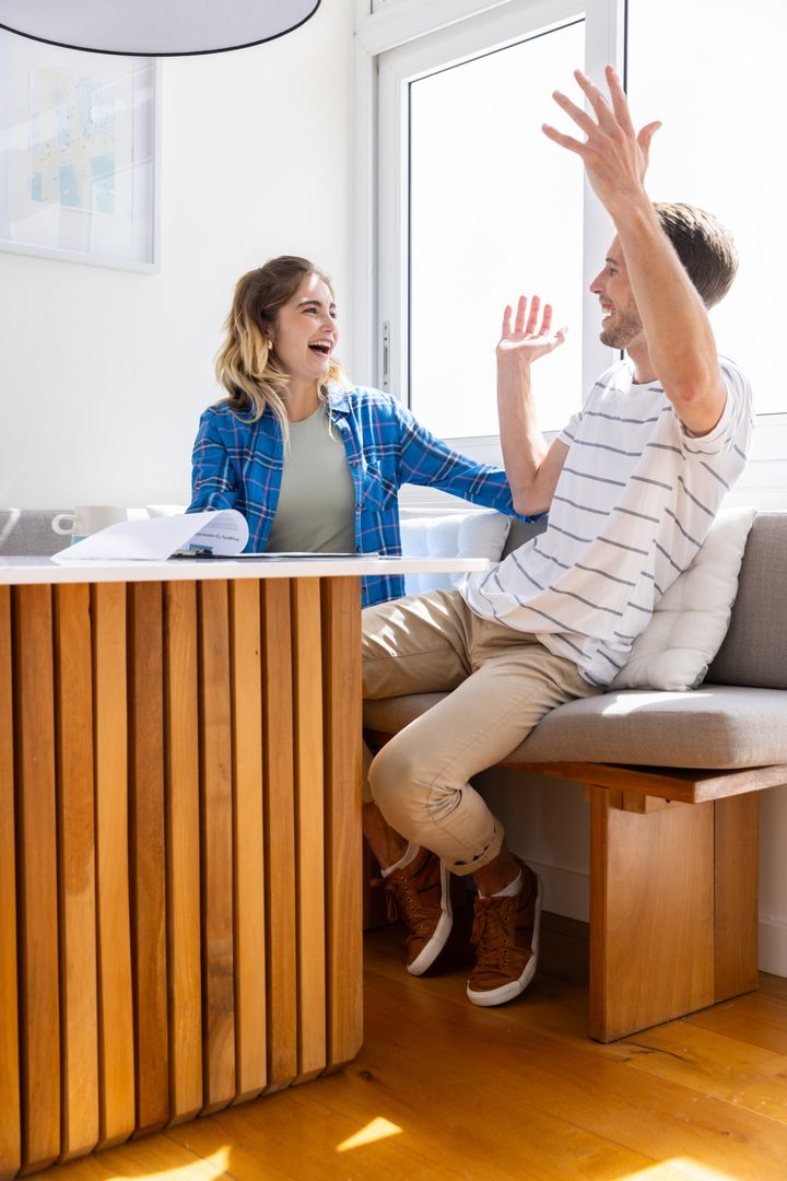 Happy Couple Discussing Home Plans With Window Light