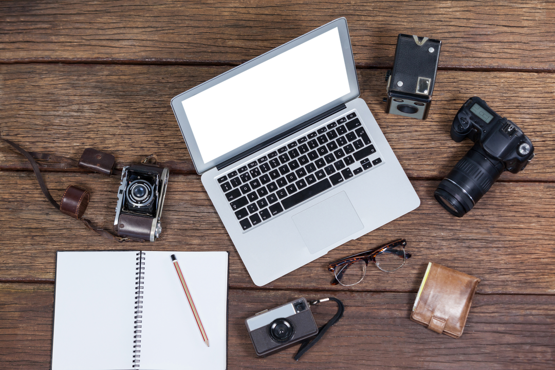 Transparent Laptop Display with Cameras and Notebook on Wooden Table - Download Free Stock Images Pikwizard.com