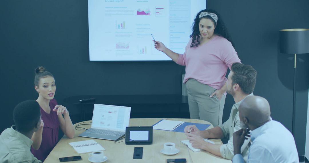 Diverse Business Team Analyzing Graphs During Meeting