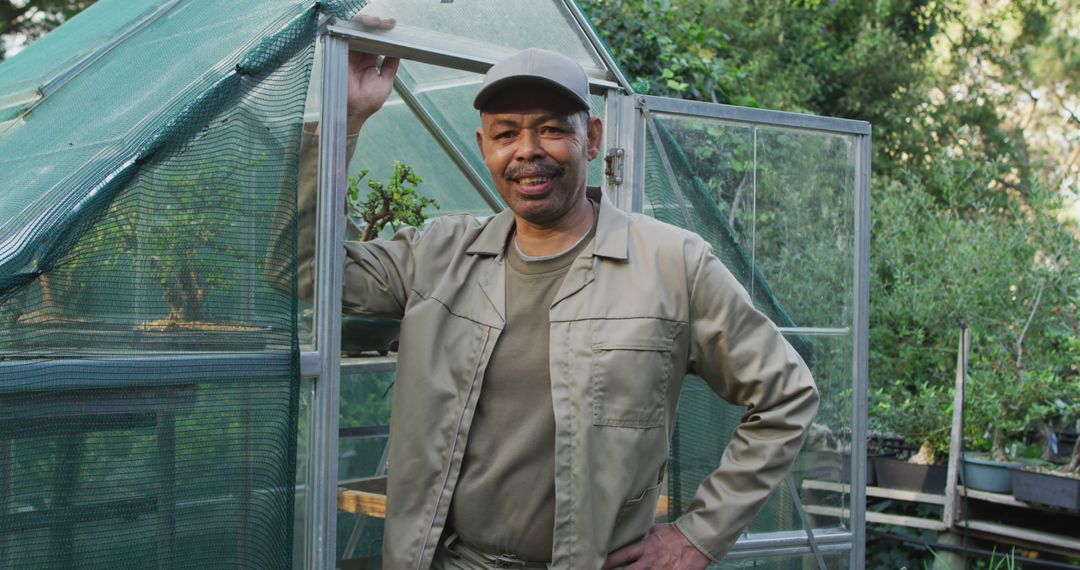 Senior Man Smiling Outside Greenhouse in Garden - Free Images, Stock Photos and Pictures on Pikwizard.com