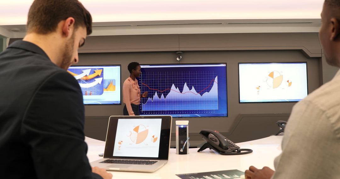 Collaborative Team Analyzing Financial Graphs in Meeting Room