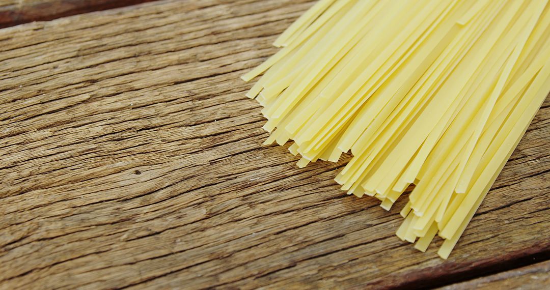 Uncooked Fettuccine Pasta on Rustic Wooden Surface - Free Images, Stock Photos and Pictures on Pikwizard.com