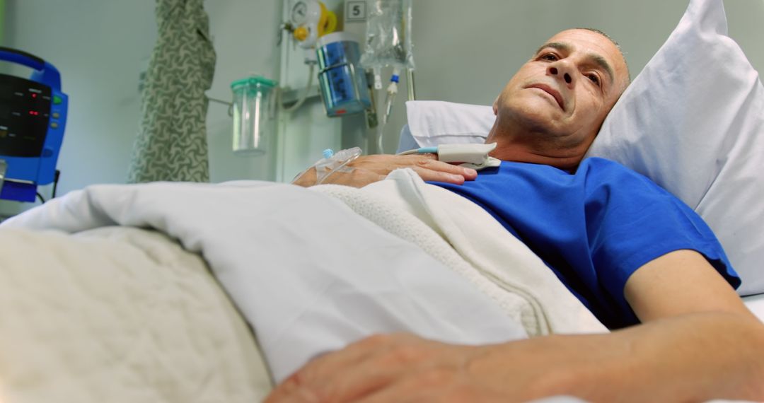 Elderly Patient Resting in Hospital Bed Under Medical Care - Free Images, Stock Photos and Pictures on Pikwizard.com