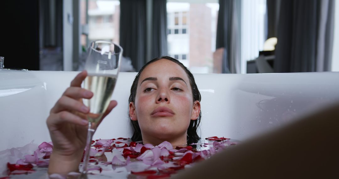 Woman Relaxing in Bathtub with Rose Petals and Champagne - Free Images, Stock Photos and Pictures on Pikwizard.com