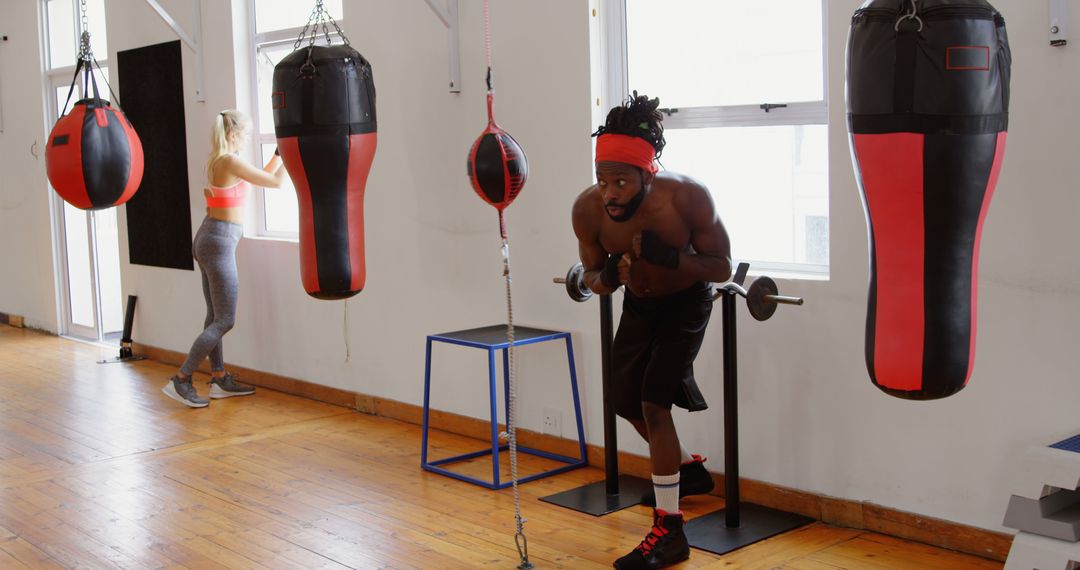 Man Exercising with Punching Bag in Fitness Gym - Free Images, Stock Photos and Pictures on Pikwizard.com