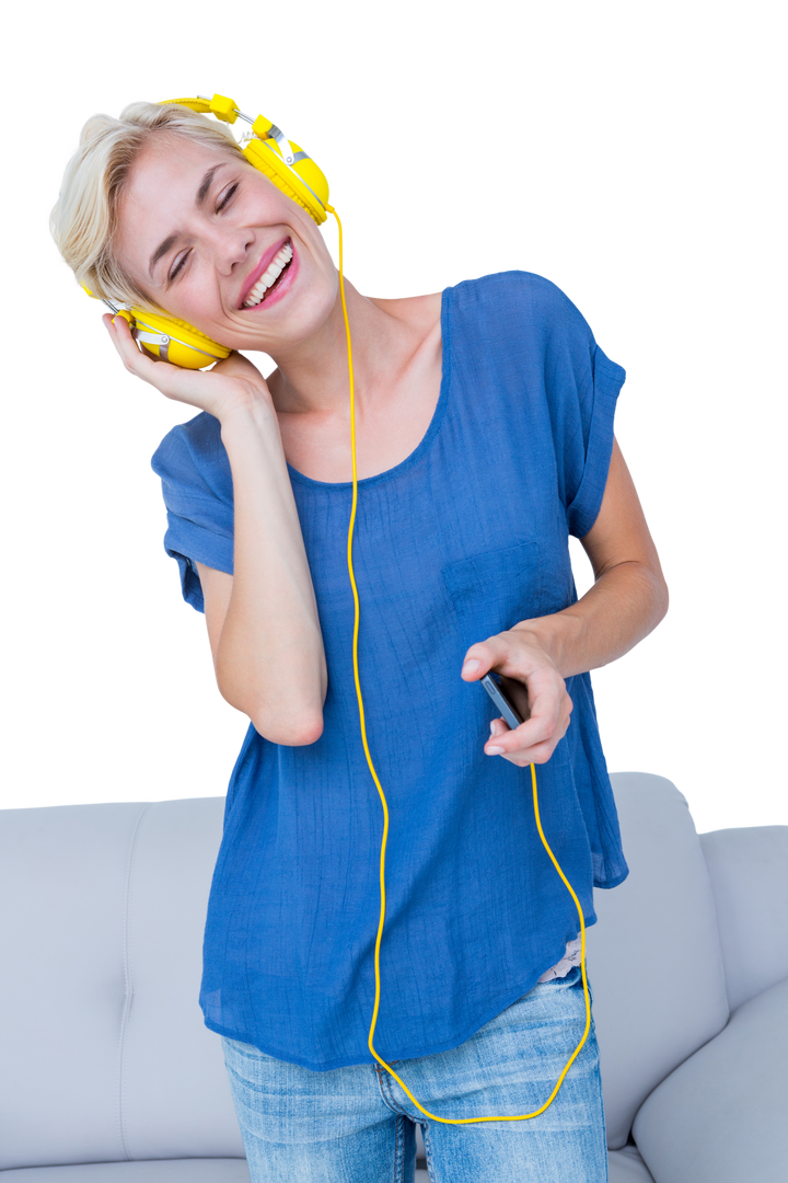 Cheerful Young Woman Wearing Headphones and Holding Mobile Phone, Clipping Path Included - Download Free Stock Images Pikwizard.com