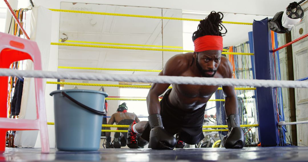 Boxer Focused on Intense Training in Gym Boxing Ring - Free Images, Stock Photos and Pictures on Pikwizard.com