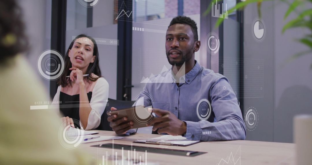 Professionals Analyzing Data and Charts in Modern Meeting