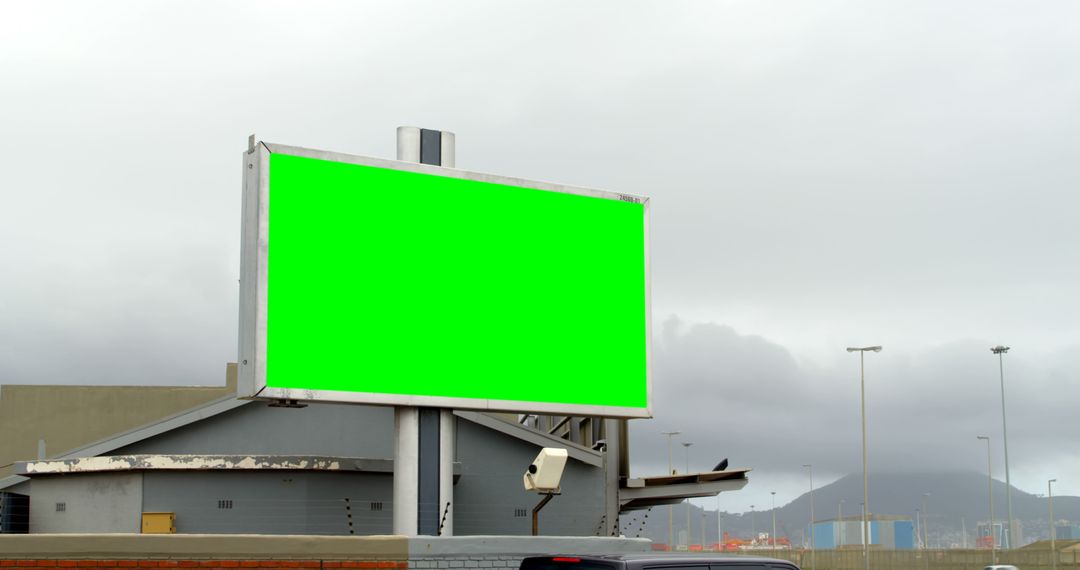 Large Green Screen Billboard in Urban Industrial Area - Free Images, Stock Photos and Pictures on Pikwizard.com