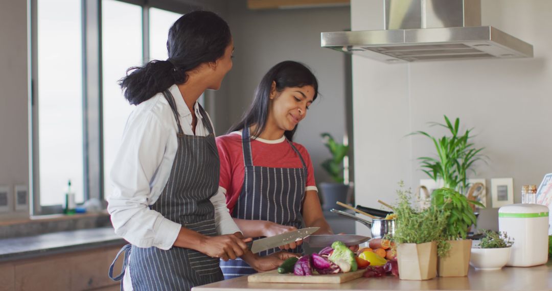 Diverse Women Smiling and Cooking Fresh Vegetables in Modern Kitchen - Free Images, Stock Photos and Pictures on Pikwizard.com