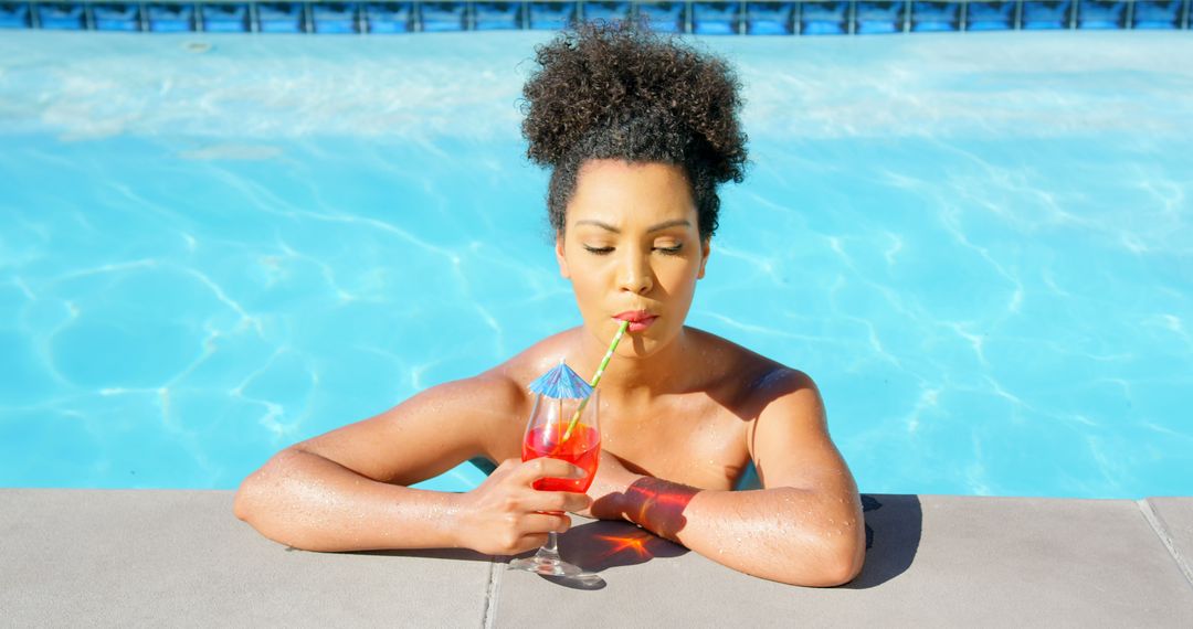 Woman Relaxing in Pool Drinking Refreshing Tropical Cocktail - Free Images, Stock Photos and Pictures on Pikwizard.com