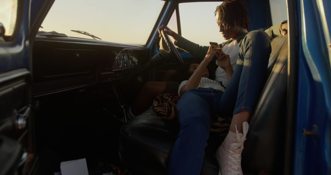 Young Couple Sitting Relaxed in Vintage Car at Sunset - Free Images, Stock Photos and Pictures on Pikwizard.com