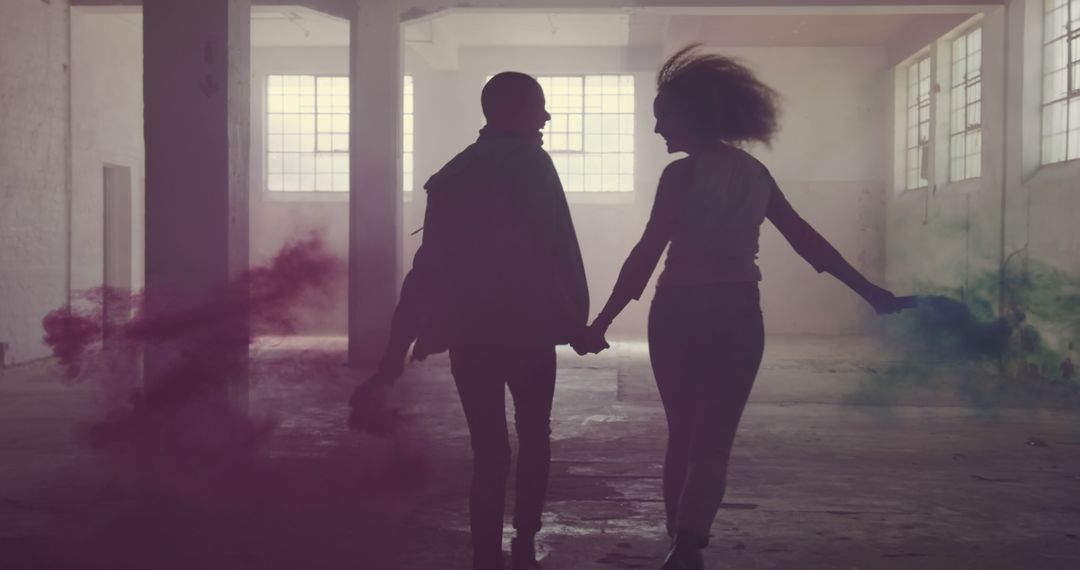 Couple Holding Hands in Abandoned Building with Colored Smoke - Free Images, Stock Photos and Pictures on Pikwizard.com