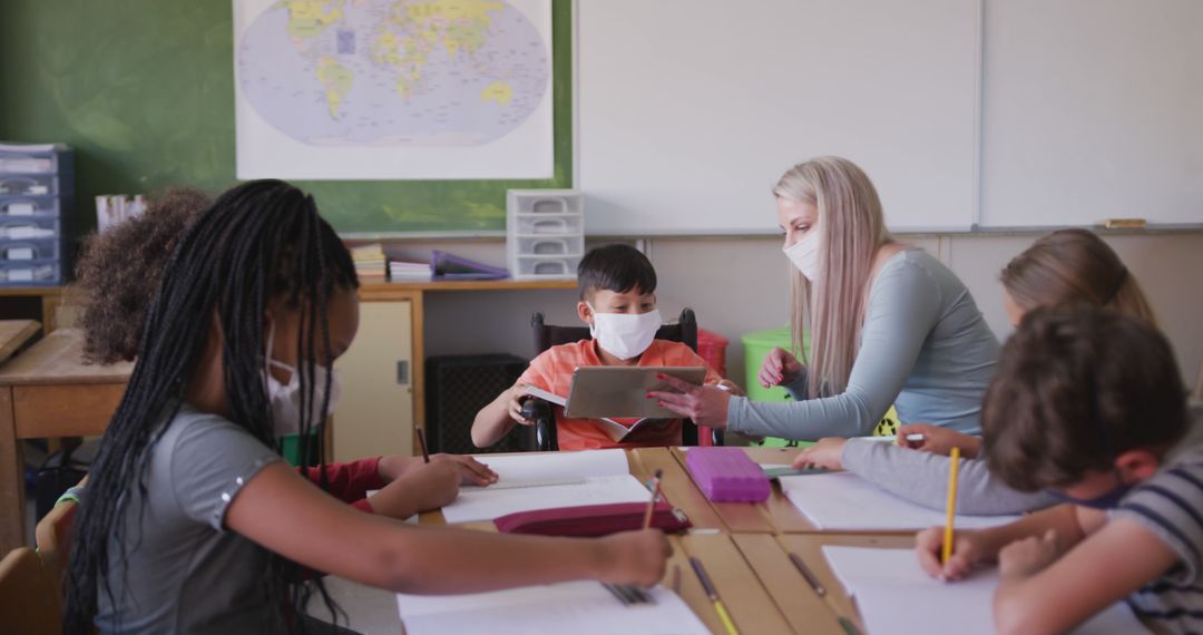 Teacher Helping Students in Classroom While Wearing Masks - Free Images, Stock Photos and Pictures on Pikwizard.com