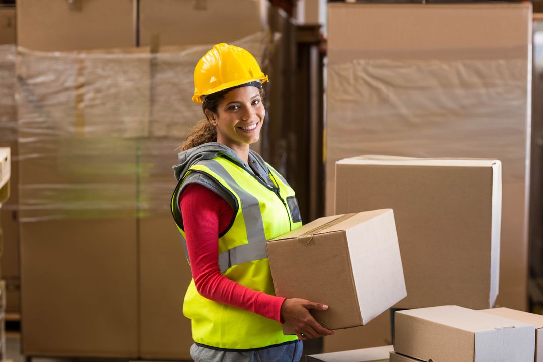 Warehouse Employee Handling Cardboard Box in Storage Facility