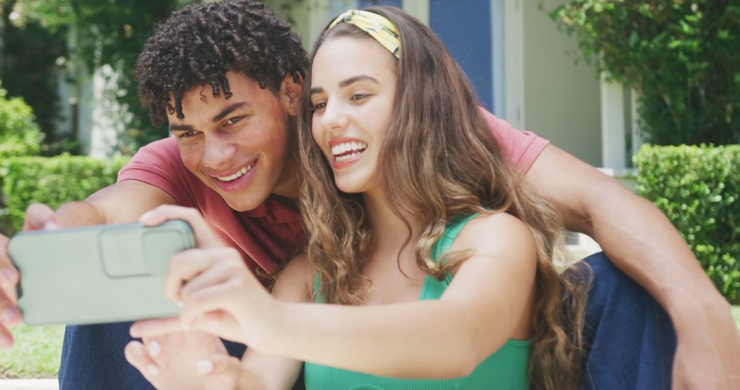 Smiling Couple Taking Selfie in Sunny Garden