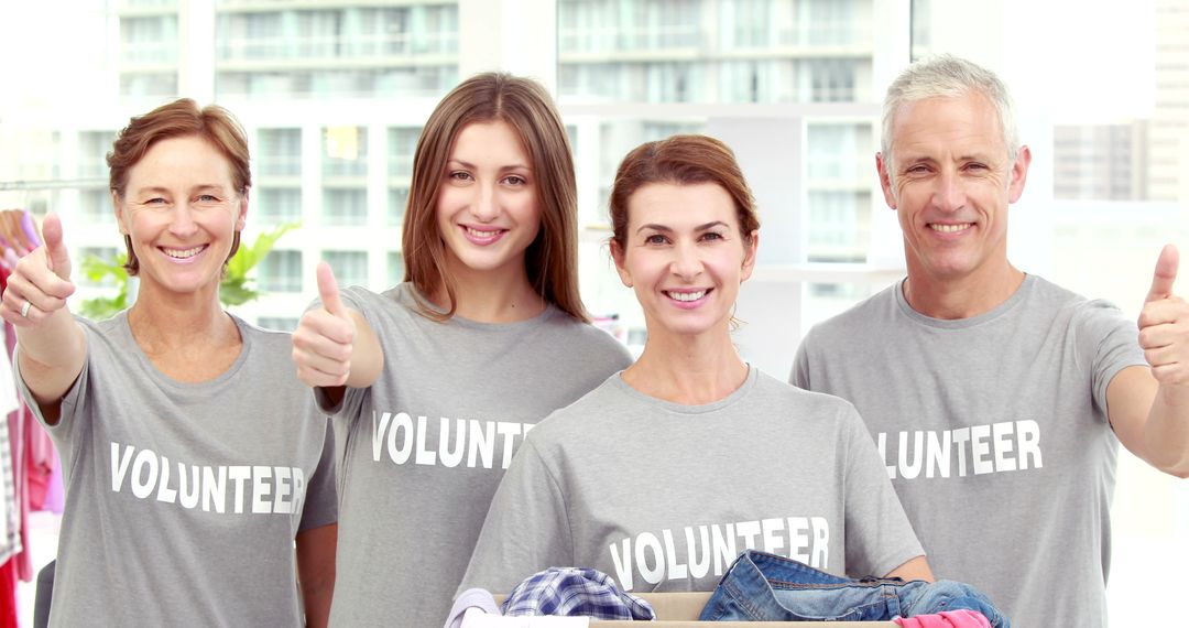 Diverse group of volunteers giving thumbs up - Free Images, Stock Photos and Pictures on Pikwizard.com