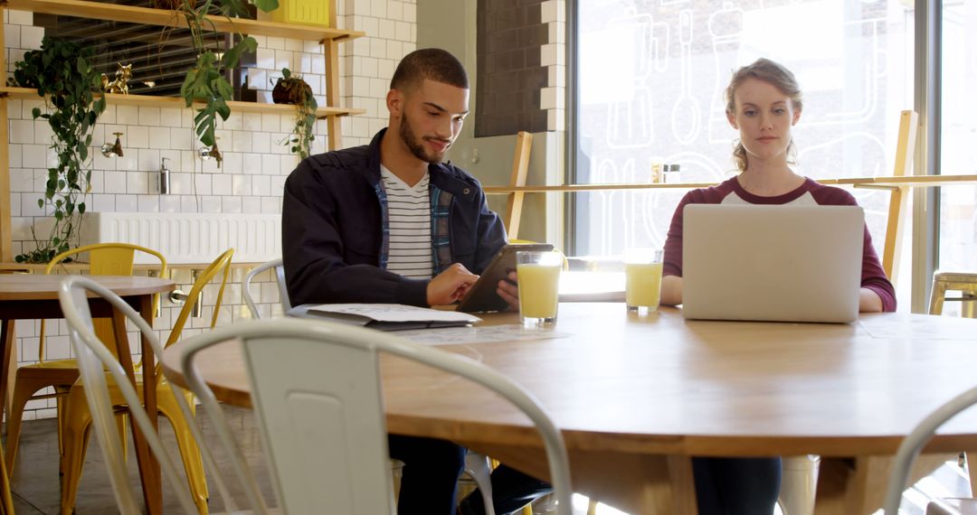 Diverse Team Collaboration with Technology in Modern Restaurant