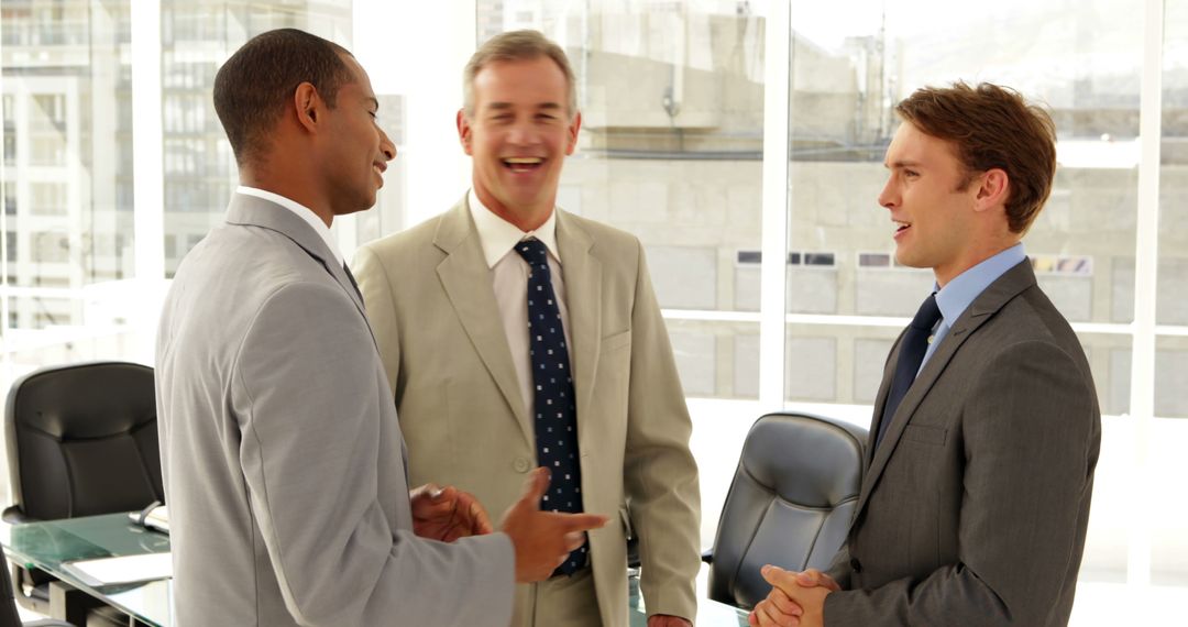 Businessmen Engaging in Office Conversation - Free Images, Stock Photos and Pictures on Pikwizard.com