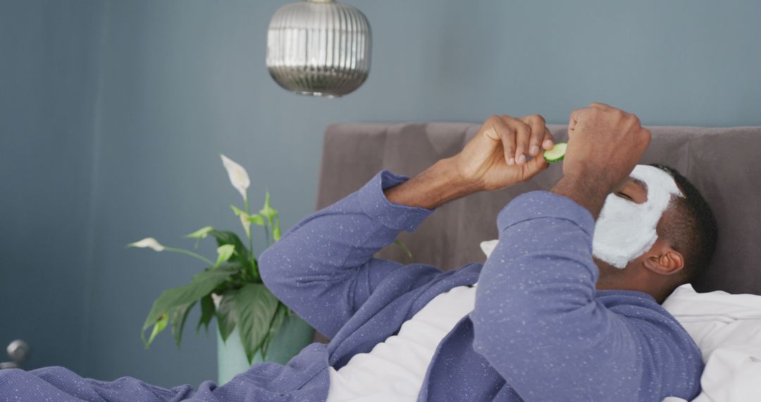 Man Enjoying Face Mask and Cucumber Slices, Relaxing in Comfort - Free Images, Stock Photos and Pictures on Pikwizard.com