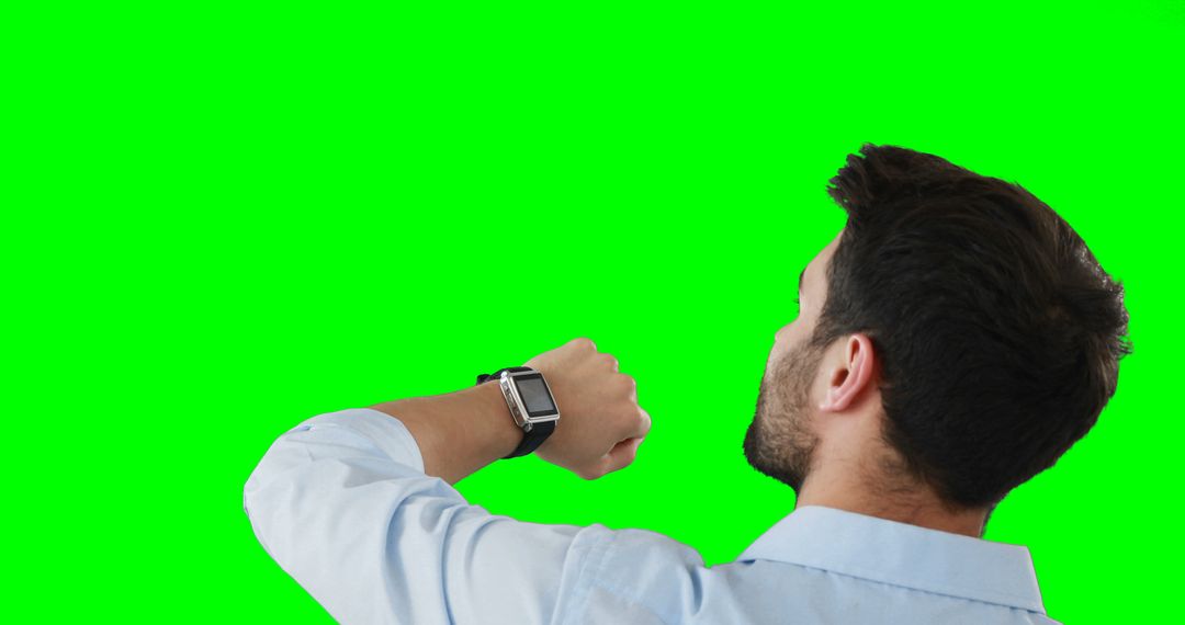 Man Checking Smartwatch with Green Screen Background - Free Images, Stock Photos and Pictures on Pikwizard.com